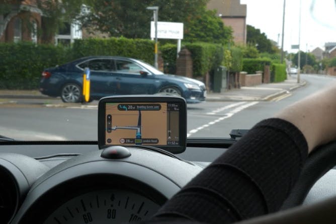 A person using a Sat Nav to help them during their mock driving test