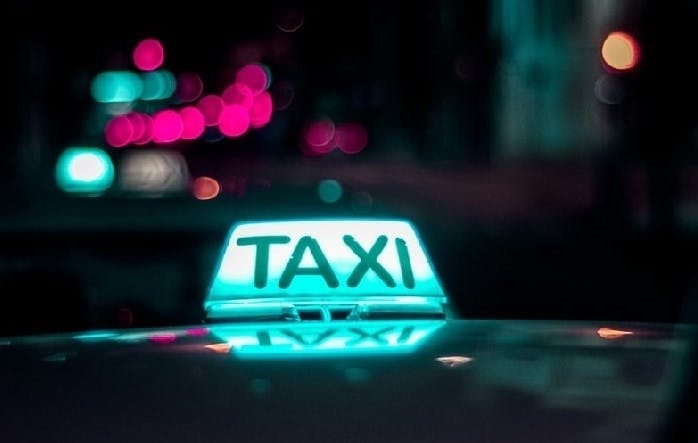 photograph of an illuminated taxi roof sign