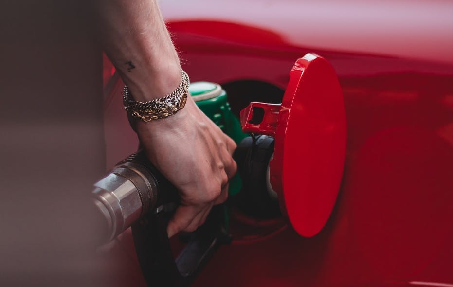 Person filling a car with petrol