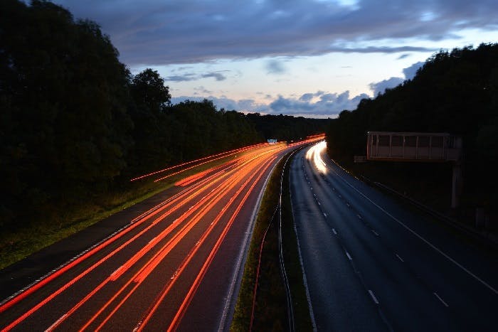 Motorway lanes at night with car lights 