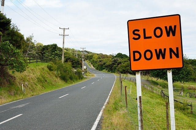 A road sign saying slow down