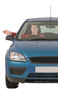 Driver performing a hand signal to indicate they want to go right