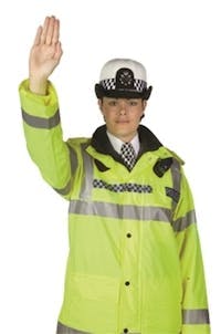 Police officer using the stopping traffic hand signal