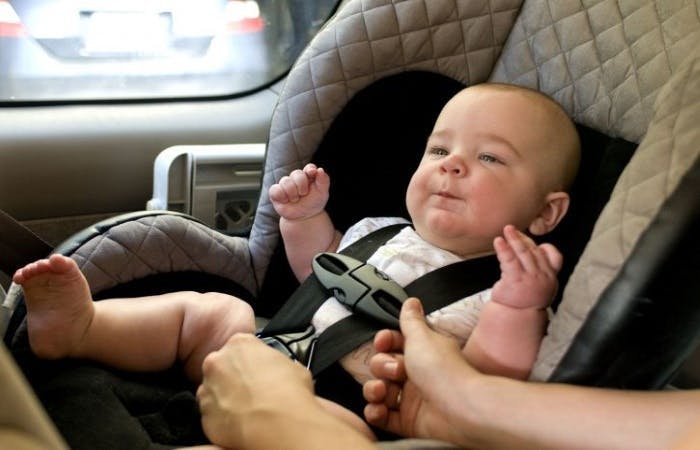 Baby secured in a child car seat