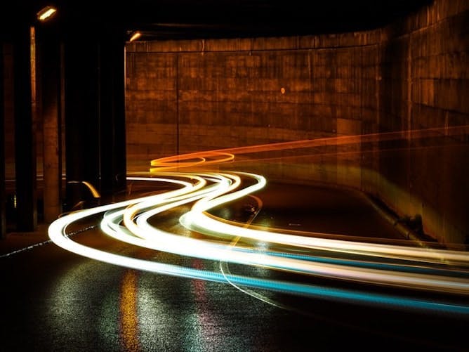 car lighttrails rushing through a tunnel