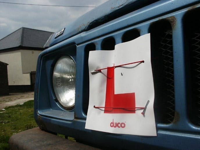 L plate attached to the front of a car