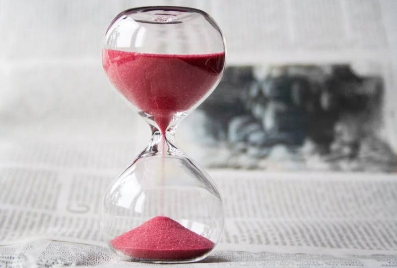 hourglass with pink sand