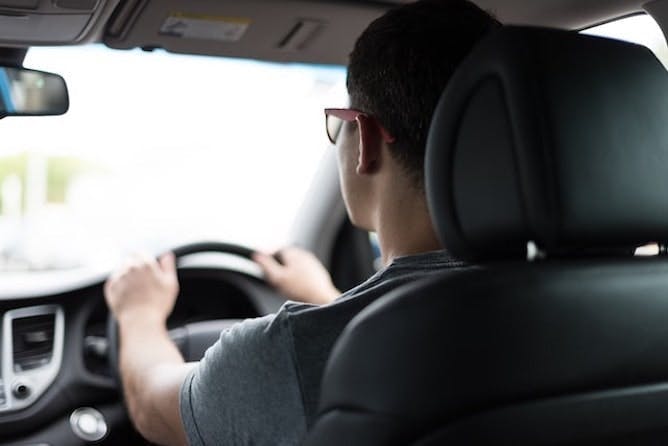 Man with glasses driving