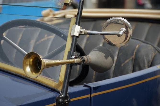 An old car with a manual horn