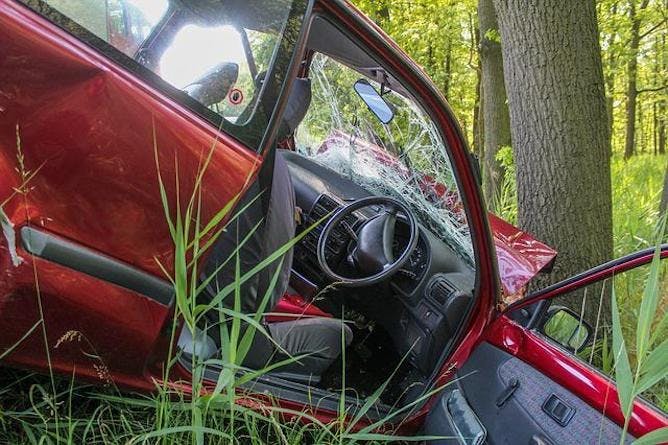 A crashed car with a cracked window screen