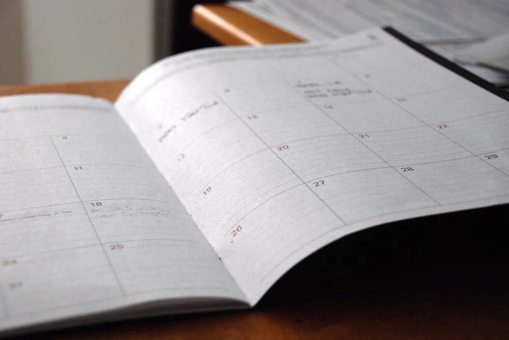 An image of a paper calendar holding a monthly schedule 