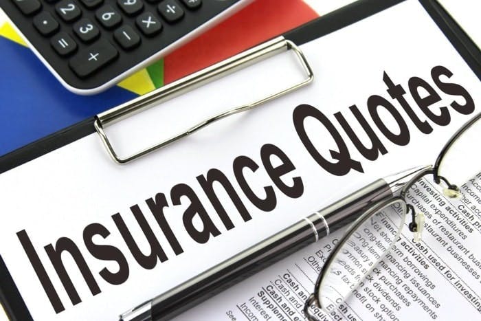 Insurance quotes on a clipboard