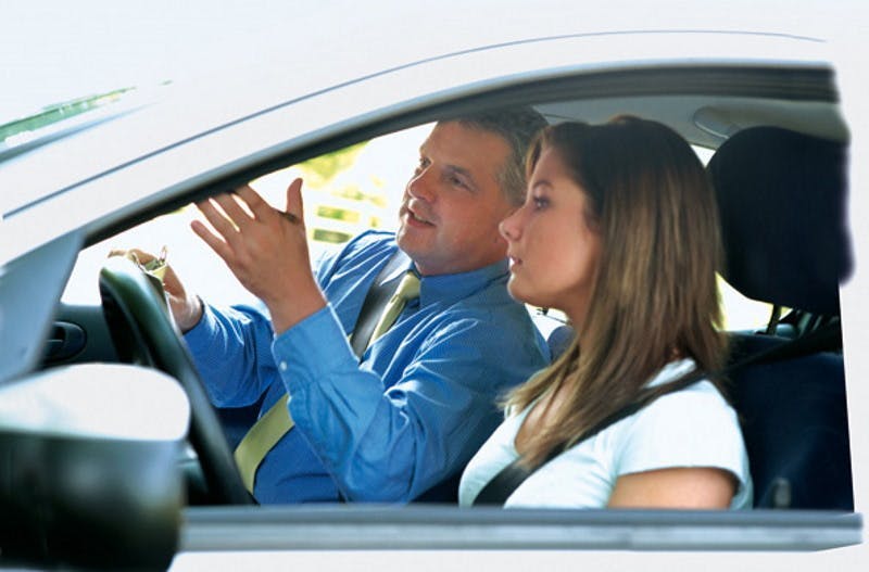 Photograph of a male driving instuctor giving instructions to a female learner driver