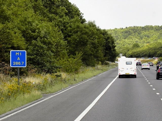 A driver location sign beside the M1