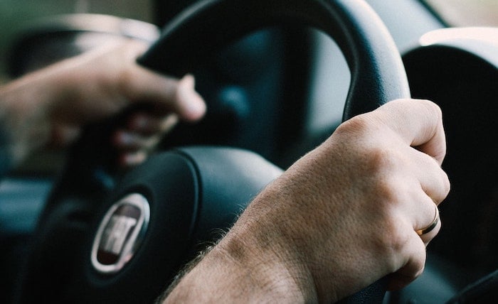 Hands holding a steering wheel
