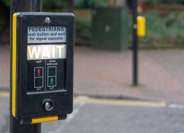 Wait sign at pedestrian crossing
