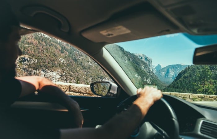 smiling man driving near Yosemite Valley