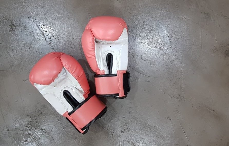 Pink boxing gloves on floor